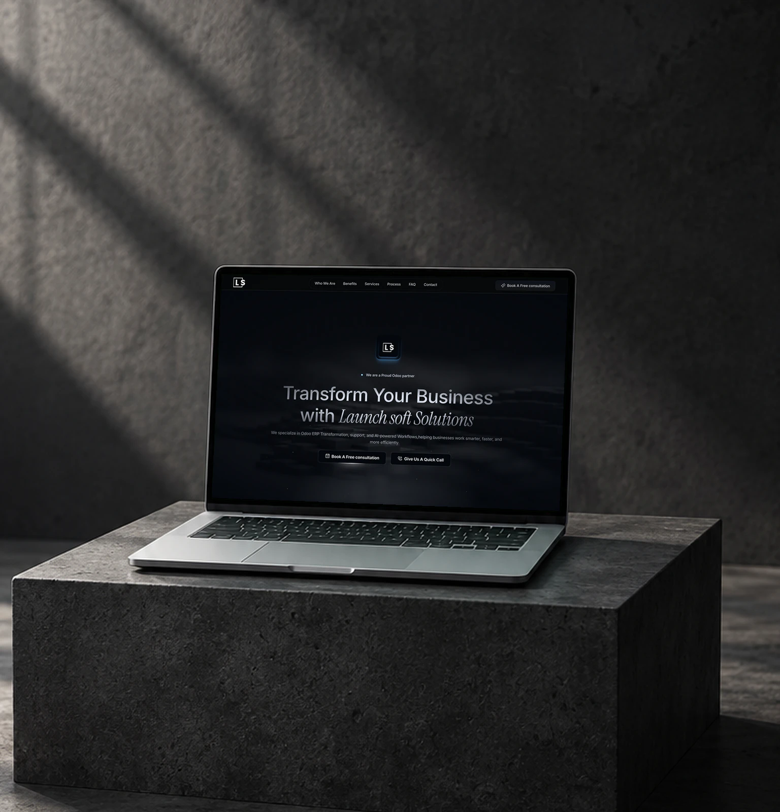 The Launchsoft landing page on a laptop in a dark concrete room