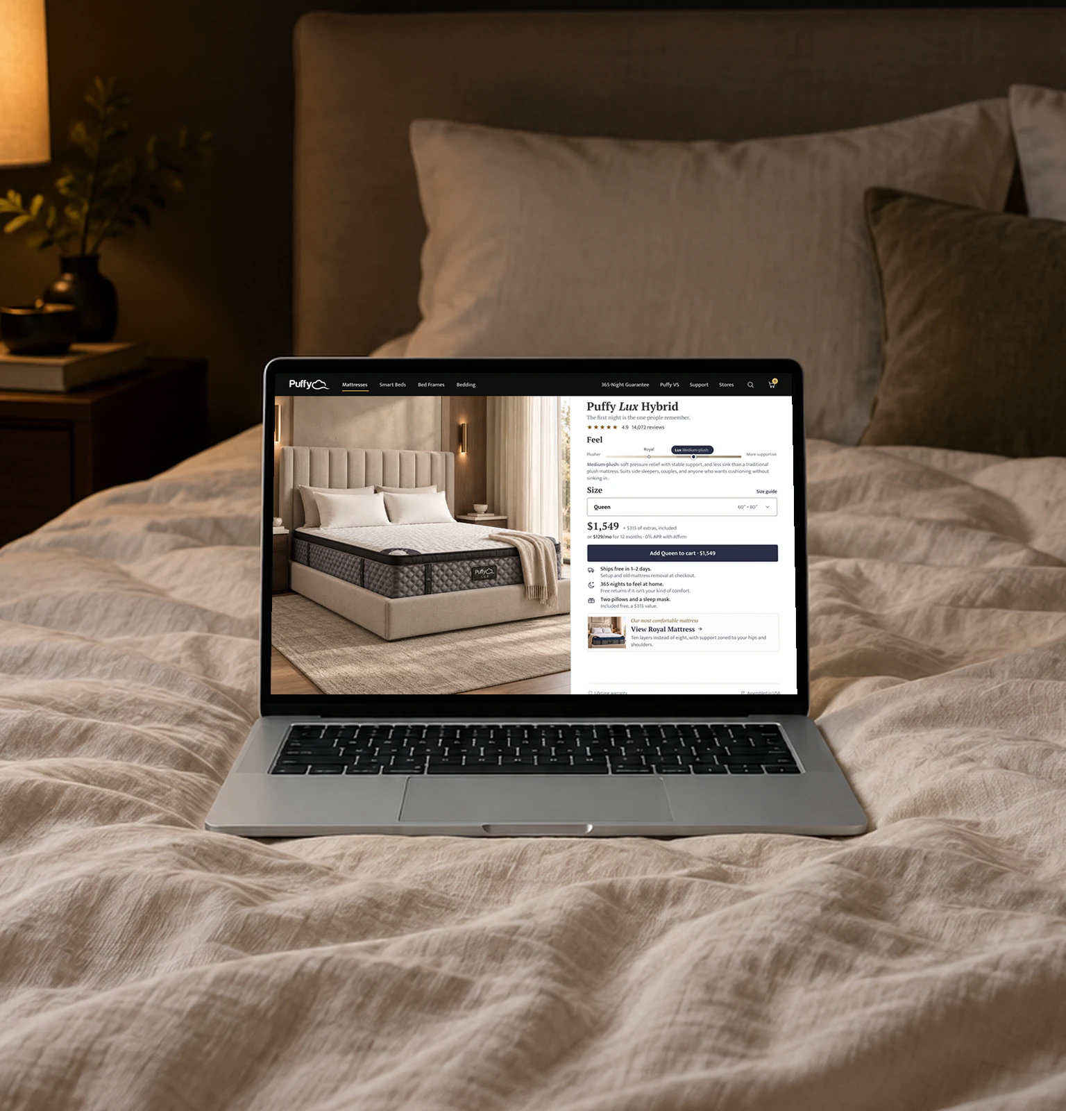 The Puffy Lux product page on a laptop resting on a linen bed